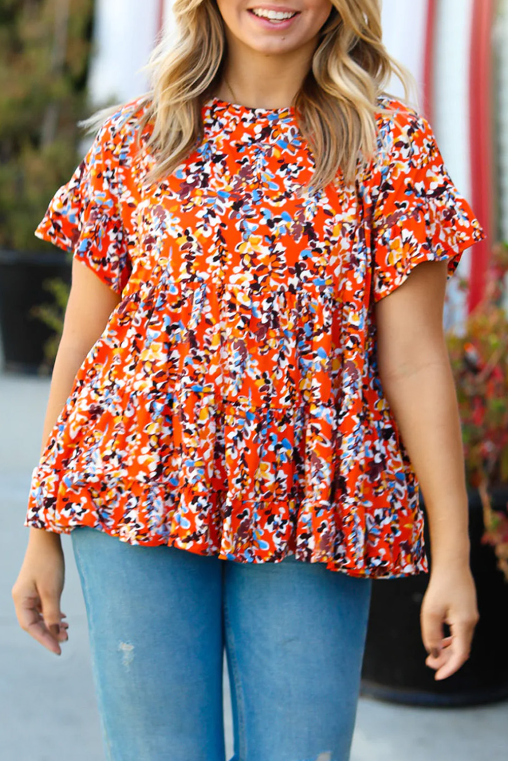 Blusa babydoll con volados y mangas con estampado floral en color naranja